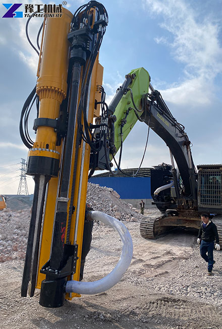 Excavator drilling and splitting rock at a construction site