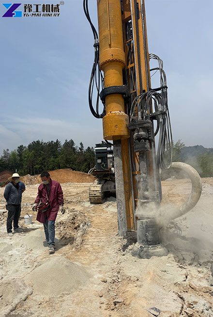 Excavator attachment drilling holes into hard rock