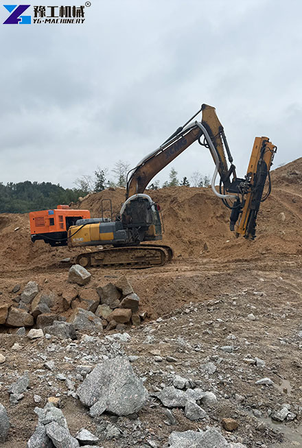 Excavator rock splitting machine breaking large rock sections