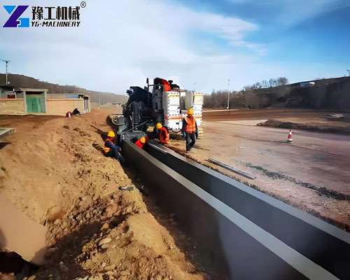 slipform curb machine extruding concrete curb on site